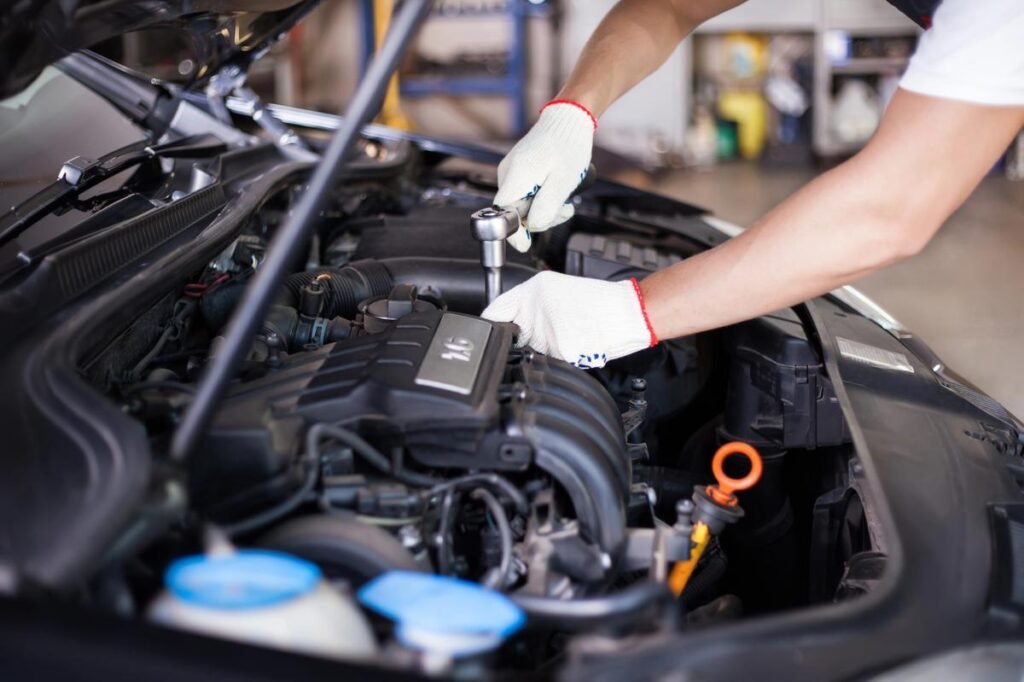Mechanic working on a car engine
